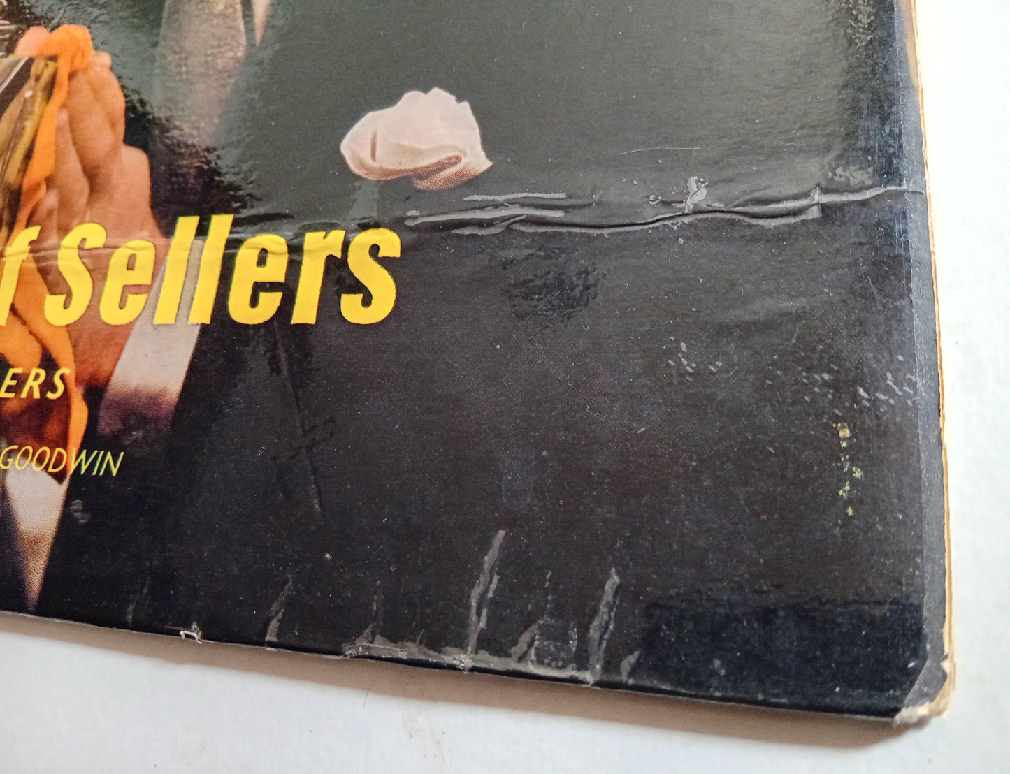 Vinyl record with 'Sellers' text and a rose, showing signs of wear.