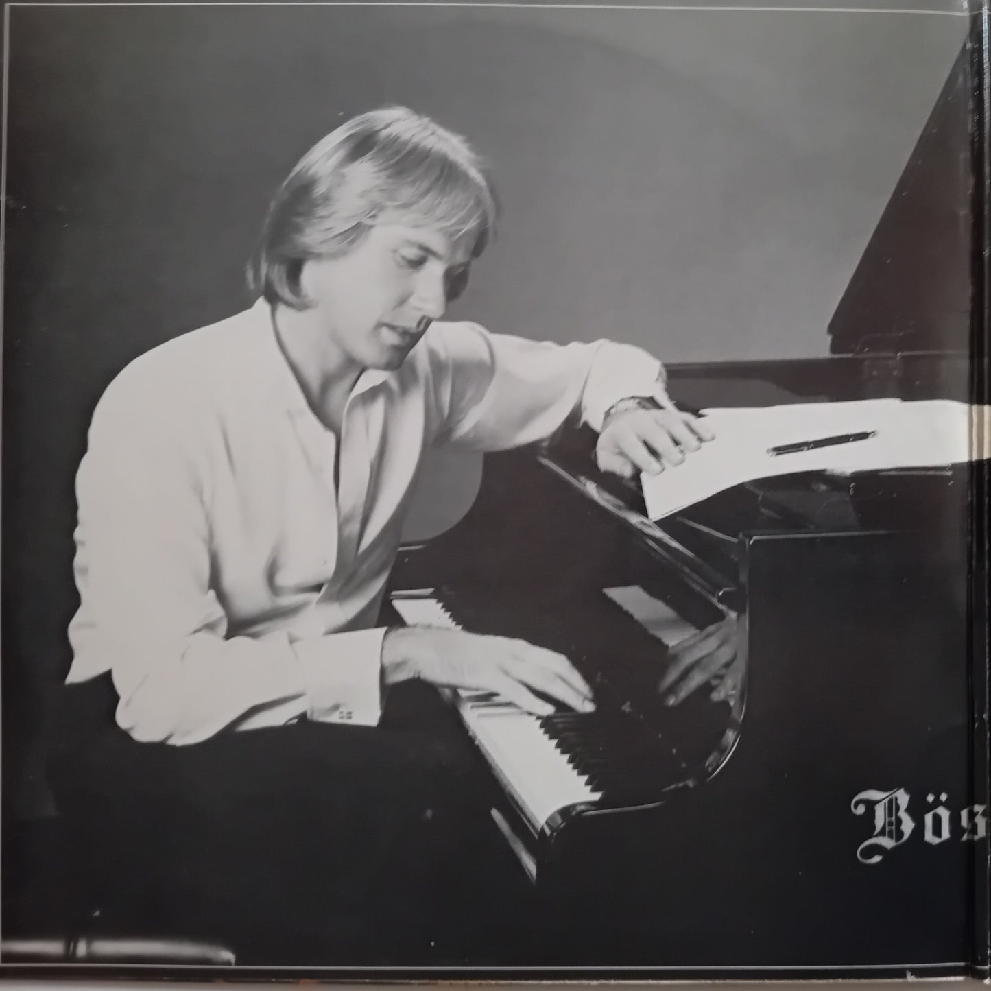 Black and white album cover featuring a man playing a grand piano, with the text 'Bös' visible in the lower right corner.