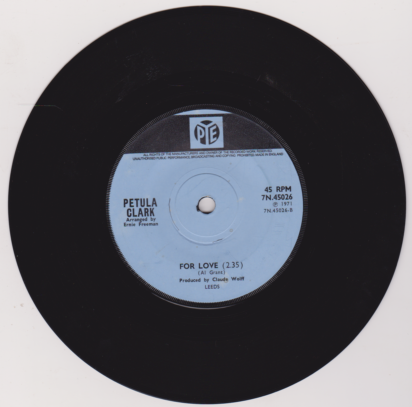 Black vinyl record with white label featuring Petula Clark's 'For Love' on a white background