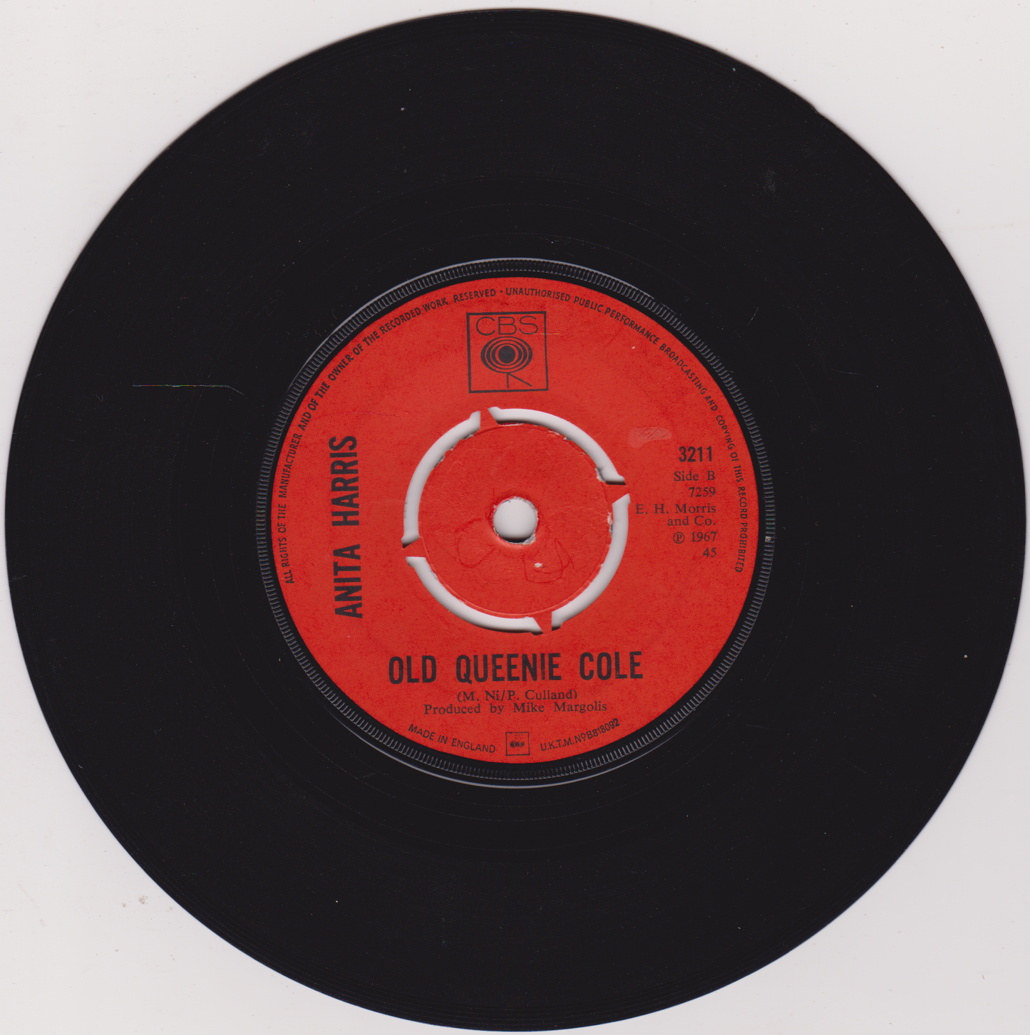 Vinyl record label with red center and black outer ring on a white background