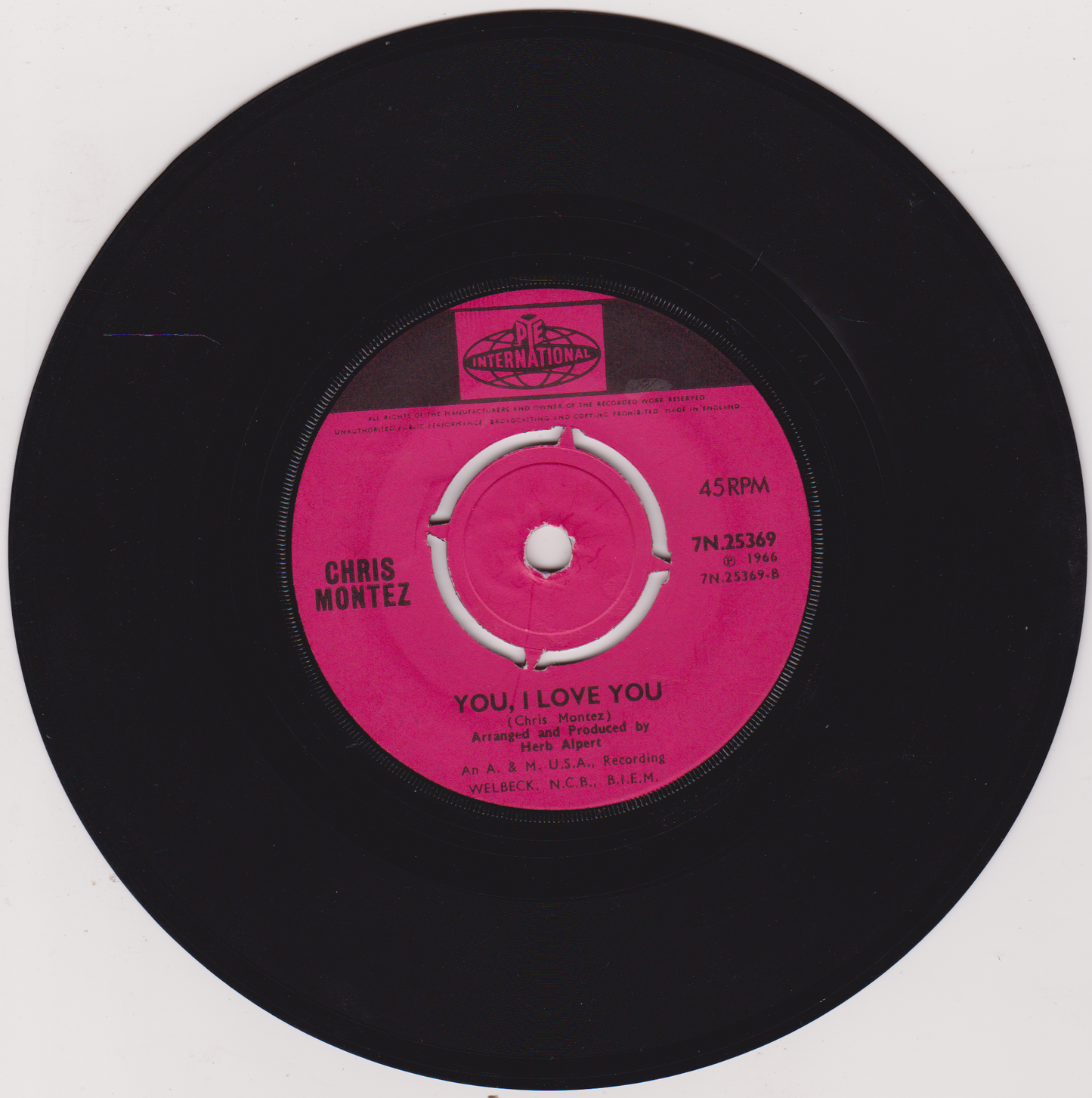 Vinyl record with a pink label featuring 'Chris Montez' and 'You Love Me' text.