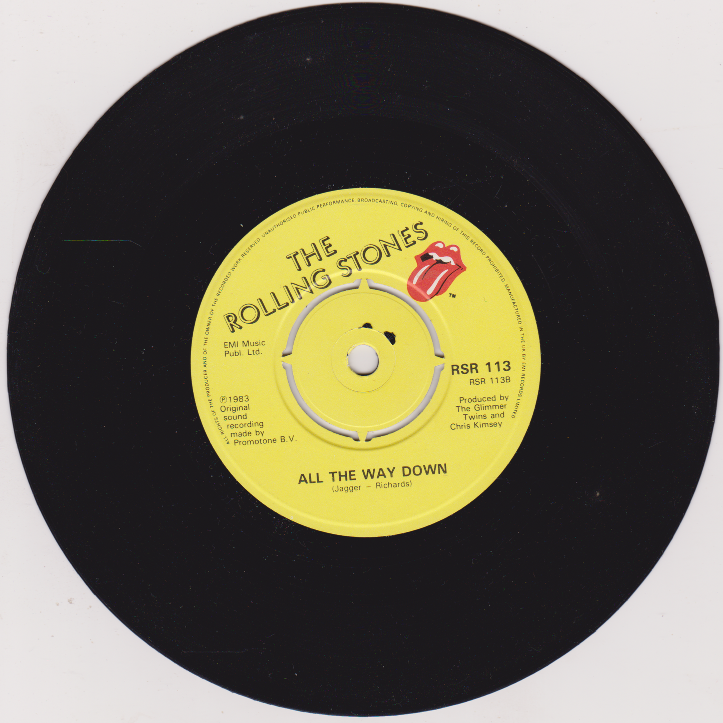 Vinyl record with yellow label featuring The Rolling Stones logo and text.
