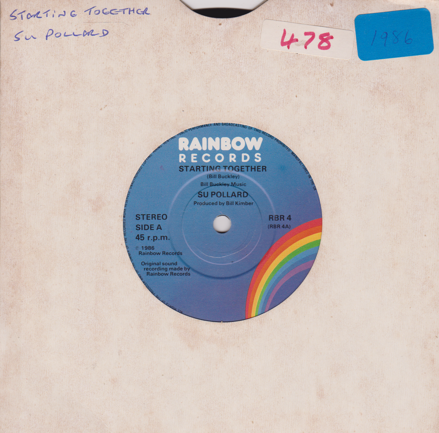 Vinyl record with 'Rainbow Records' label featuring a rainbow design on a beige background.