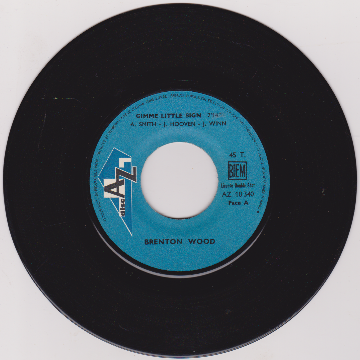 Black vinyl record with blue label featuring 'Brenton Wood' on a white background