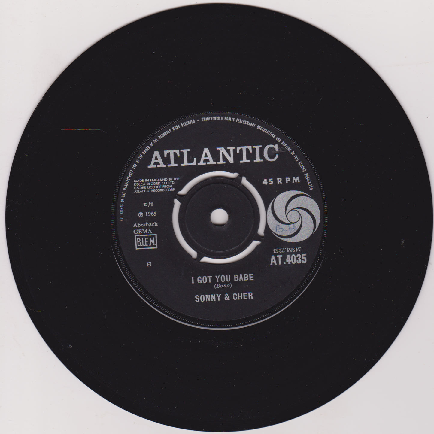 Black vinyl record with Atlantic label and Sonny & Cher's 'I Got You Babe' on a white background