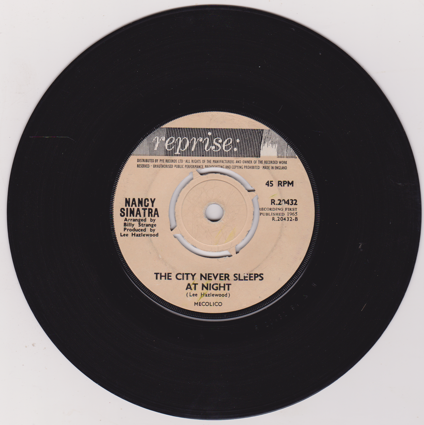 Vinyl record with a beige label featuring Nancy Sinatra's name and song title on a white background