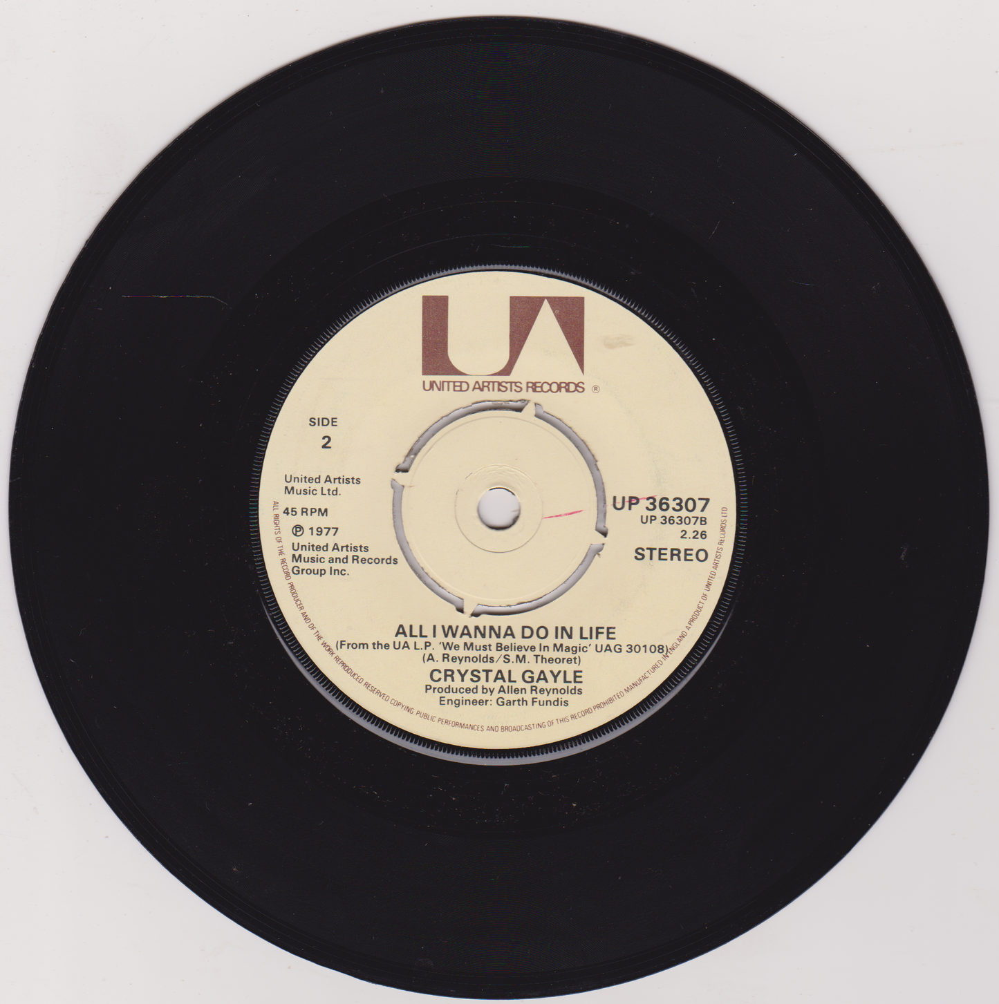 Vinyl record with a beige label featuring 'Crystal Gayle' on a white background