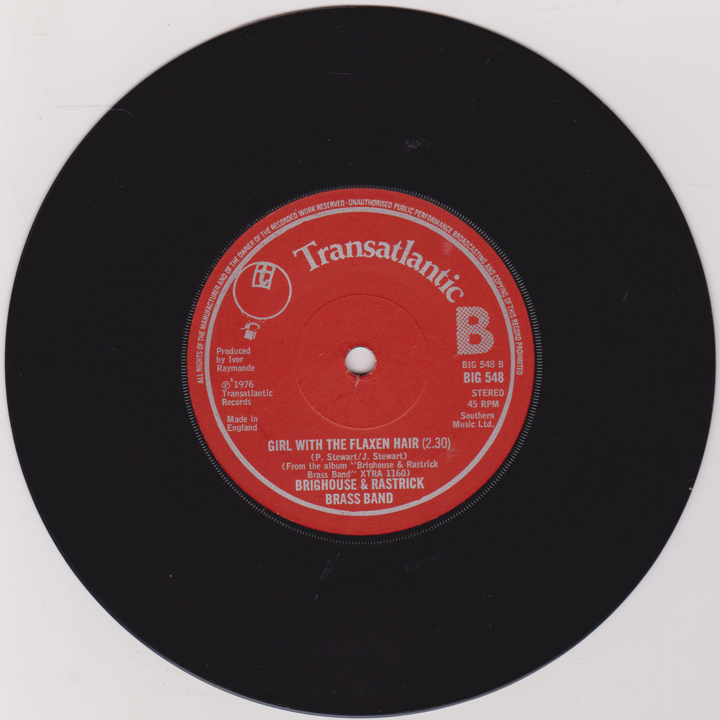 Vinyl record with a red label on a white background