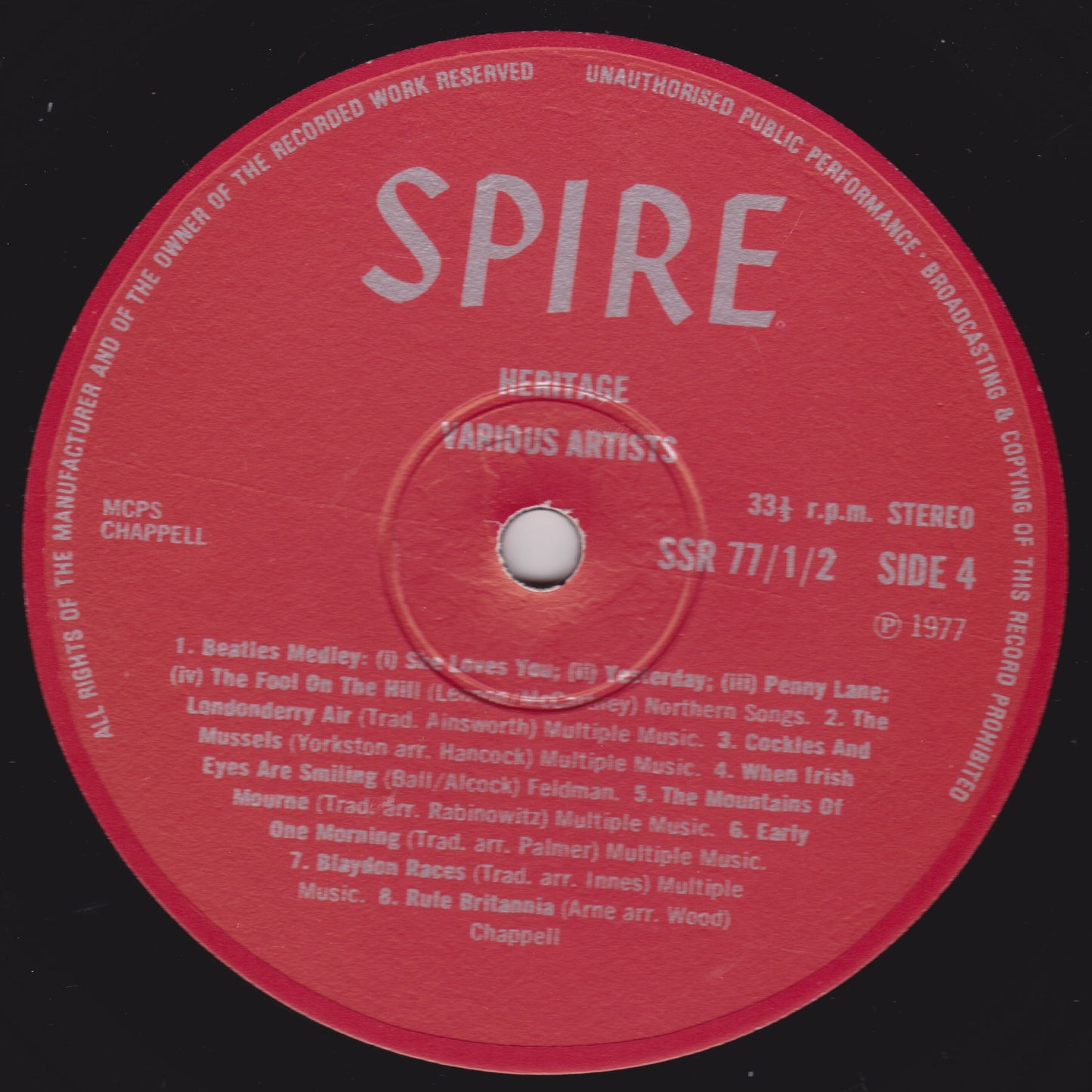 Red vinyl record label with 'SPIRE' branding and text on a black background