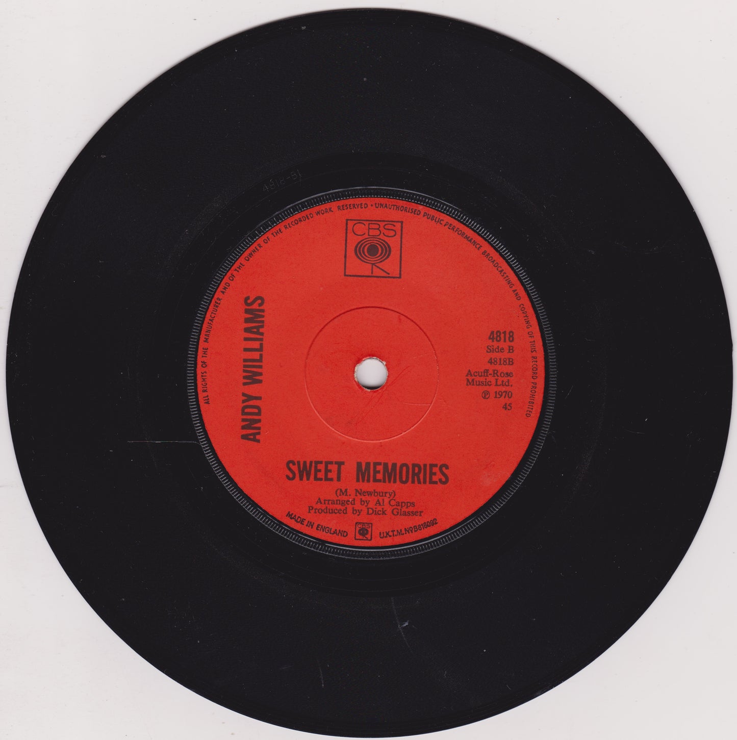 Record with red label featuring 'Andy Williams Sweet Memories' on a white background