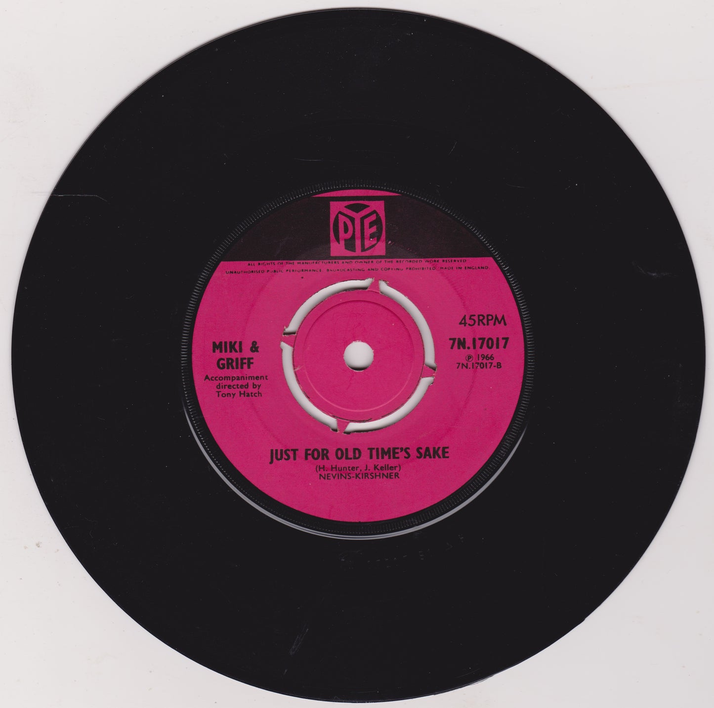 Vinyl record with a pink label on a black background