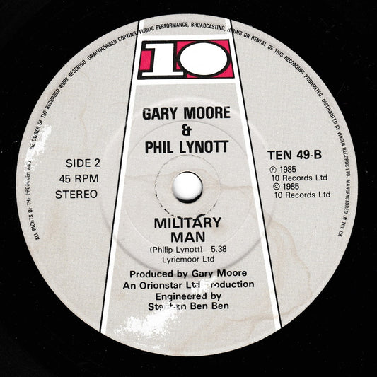 A close-up of a vinyl record label for 'Military Man' by Gary Moore & Phil Lynott, showing the 10 Records logo and track details on a black record surface.
