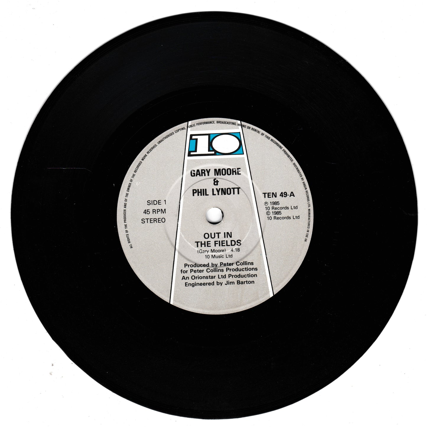 A black vinyl record with a white and blue centre label for Gary Moore and Phil Lynott's 'Out in the Fields', photographed on a white background.