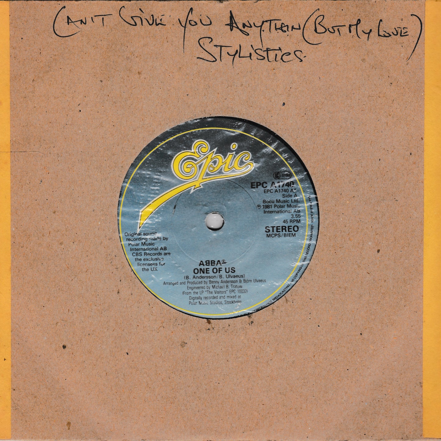 A vintage 7-inch vinyl record sleeve for ABBA's 'One of Us' on the Epic label, featuring a brown cardboard-style cover with a yellow stripe on the right and handwritten text at the top reading 'Can't Give You Anything Butty Love' and 'STYLISTICS'. The central label is blue with yellow and white details.