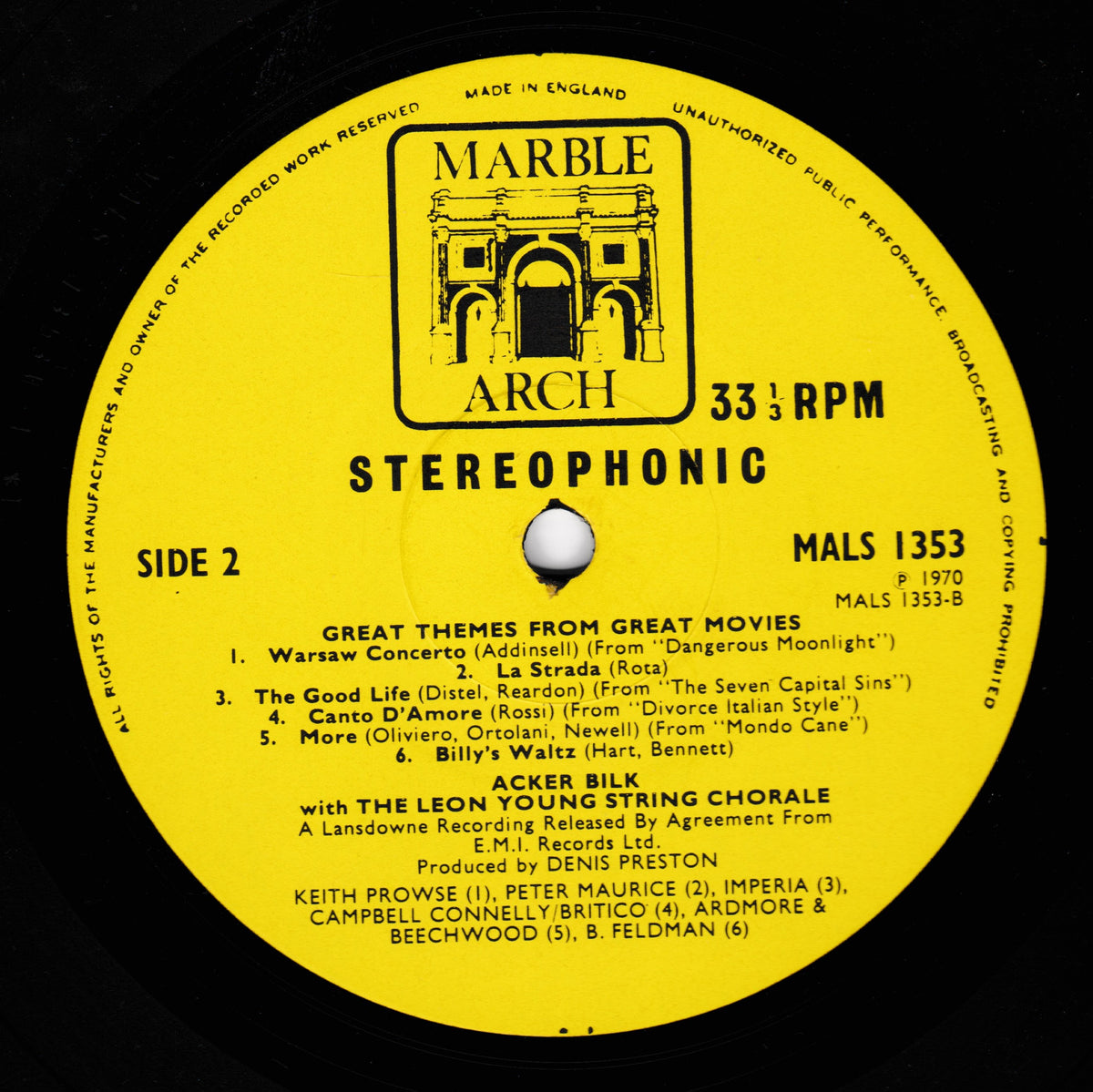 A yellow vinyl record label for Marble Arch Arch StereoPhonic, featuring black text listing the track 'Great Themes from Great Movies' with multiple artist names, on a black vinyl background.