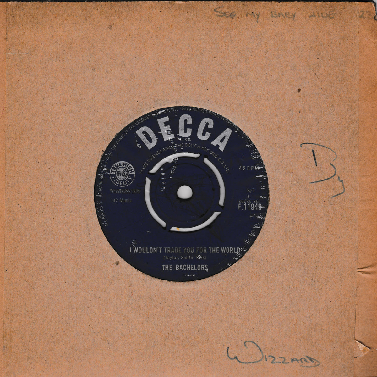 A vintage Decca 7-inch vinyl record sleeve for 'The Bachelors' - 'I Wouldn't Trade You For The World', featuring a dark blue label on a tan cardboard backing with handwritten markings.