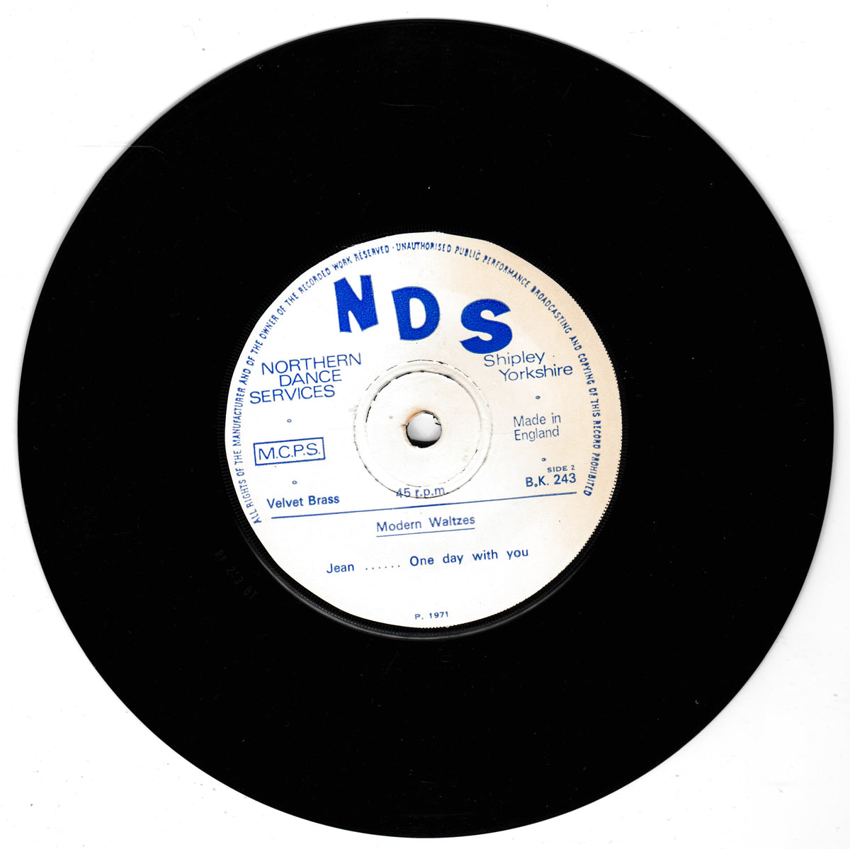 A black vinyl record with a white centre label featuring blue text. The label shows the prominent 'NDS' logo and details for the release 'Modern Waltzes' by Velvet Brass, released under the NDS label.