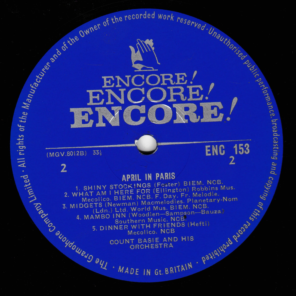 A blue vinyl record label for Encore! featuring the tracklist for 'April in Paris' with white text and a central white spindle hole, photographed against a black background.