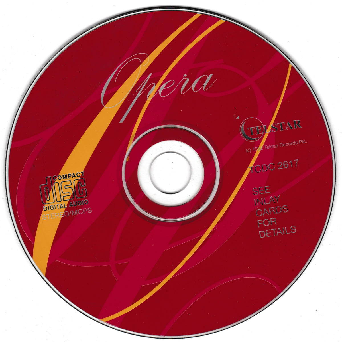 A red compact disc with yellow curved stripes, the word 'Opera' in white script, and visible text including 'CDSTAR' and 'TOPO 2817', photographed on a white background.