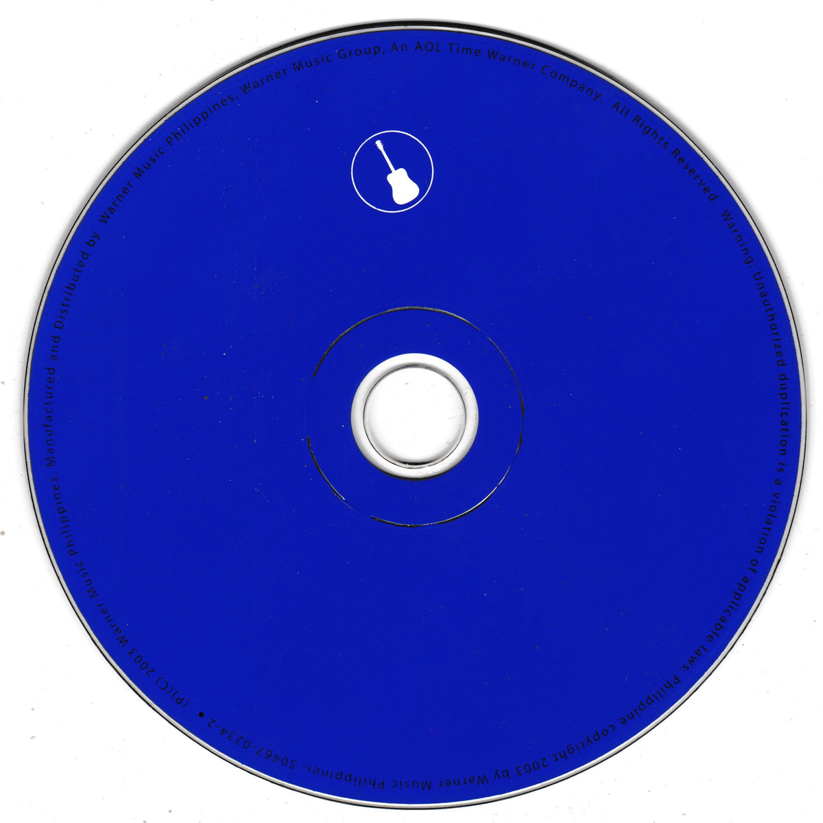 A blue compact disc with a white centre hub and a small white guitar icon near the top. The outer ring contains small black text around the edge.
