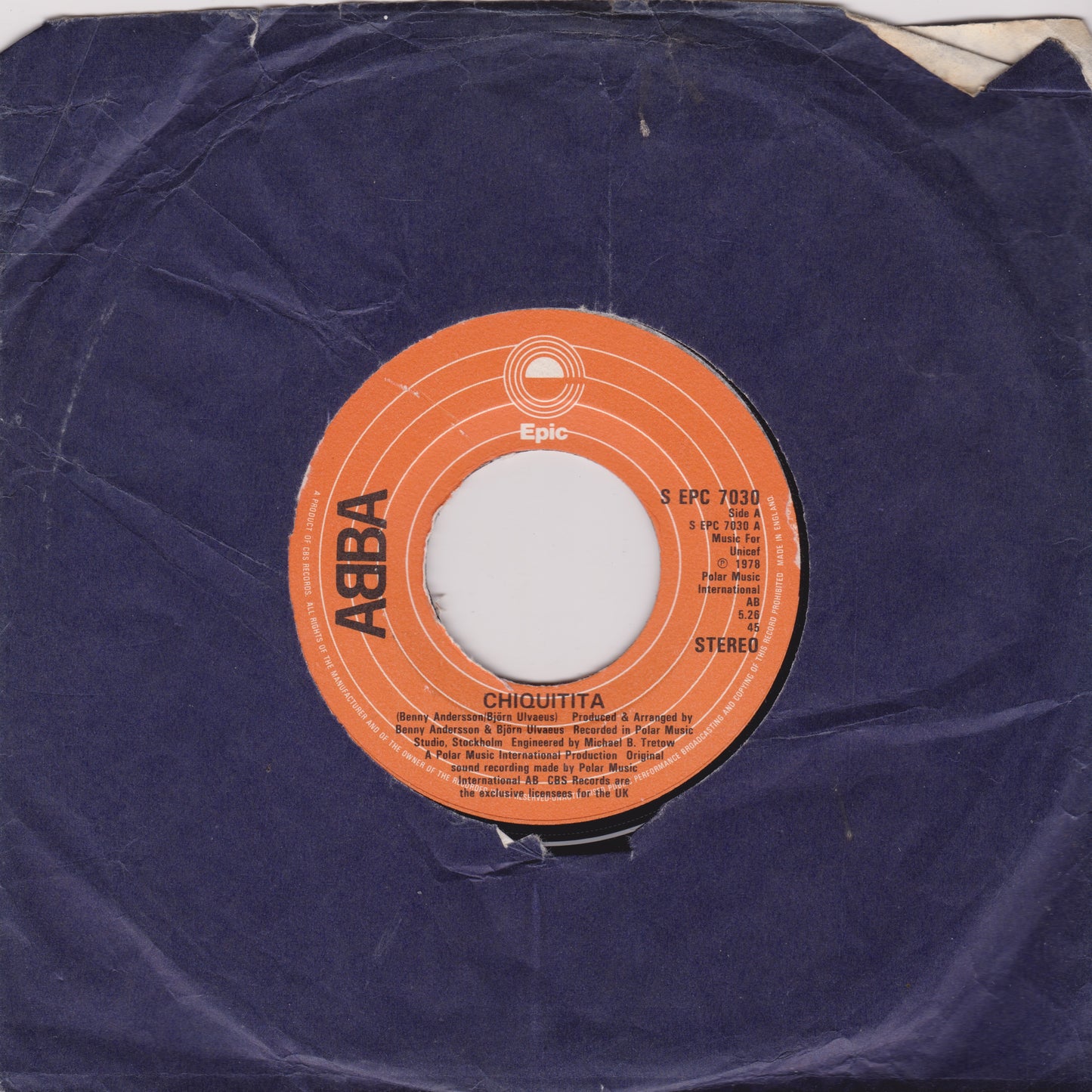 Record label with orange label on a purple vinyl record