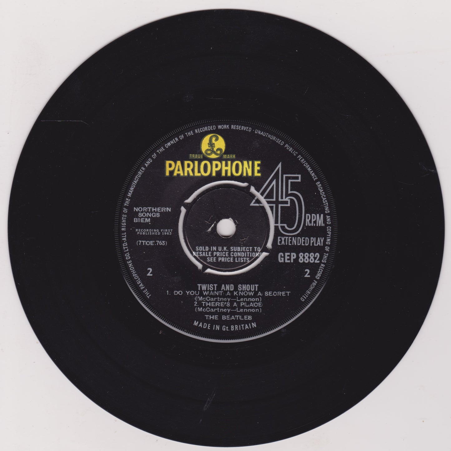 Black vinyl record with Parlophone label on a white background