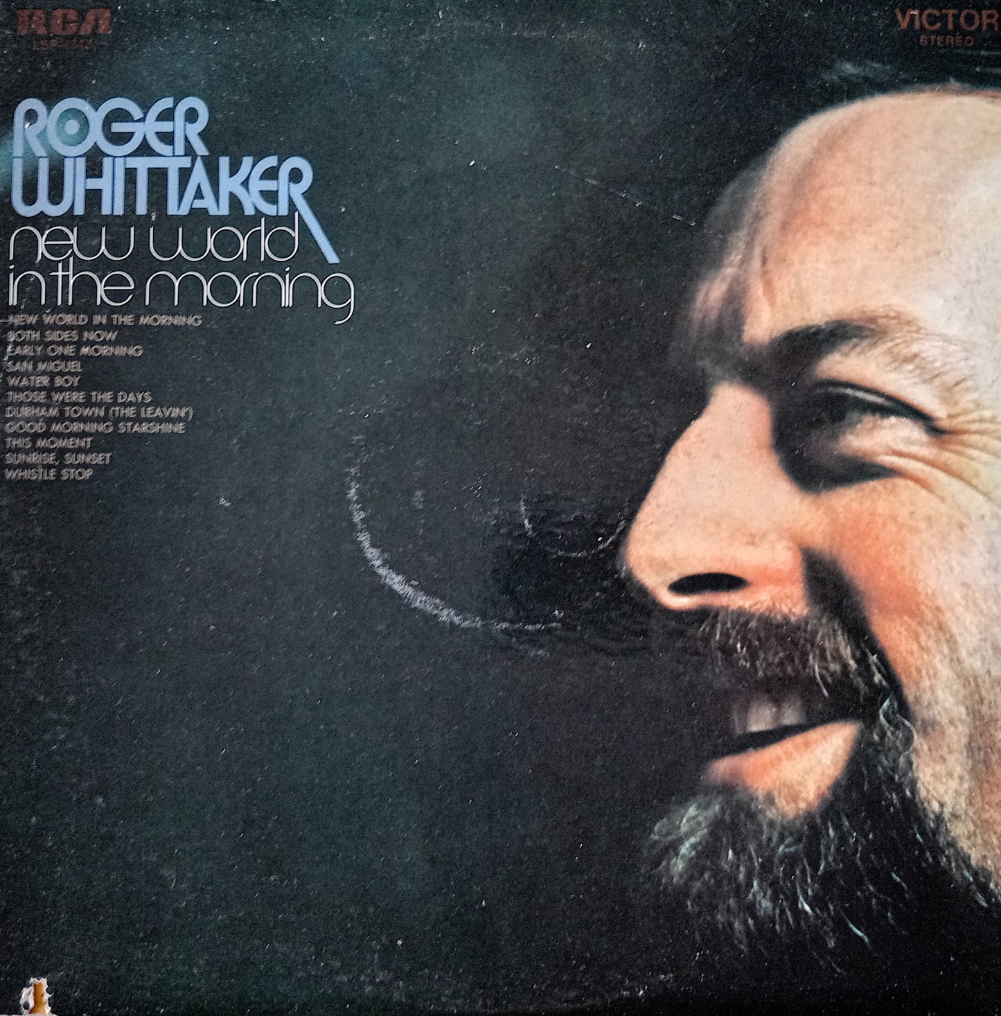 Album cover of 'New World in the Morning' by Roger Whittaker with a close-up of his face.