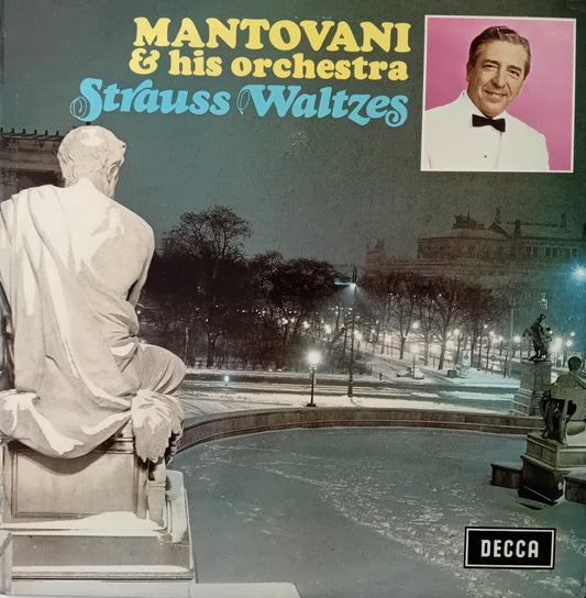 Album cover for Mantovani & his orchestra's 'Strauss Waltzes' with a statue and cityscape.