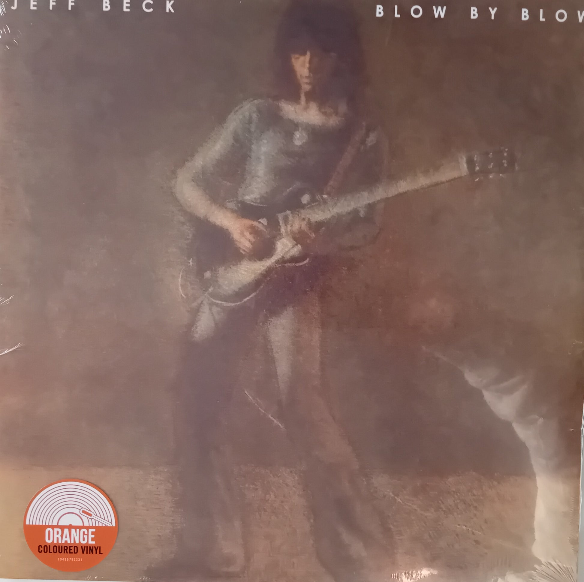 Album cover of 'Blow by Blow' by Jeff Beck with a person playing guitar.