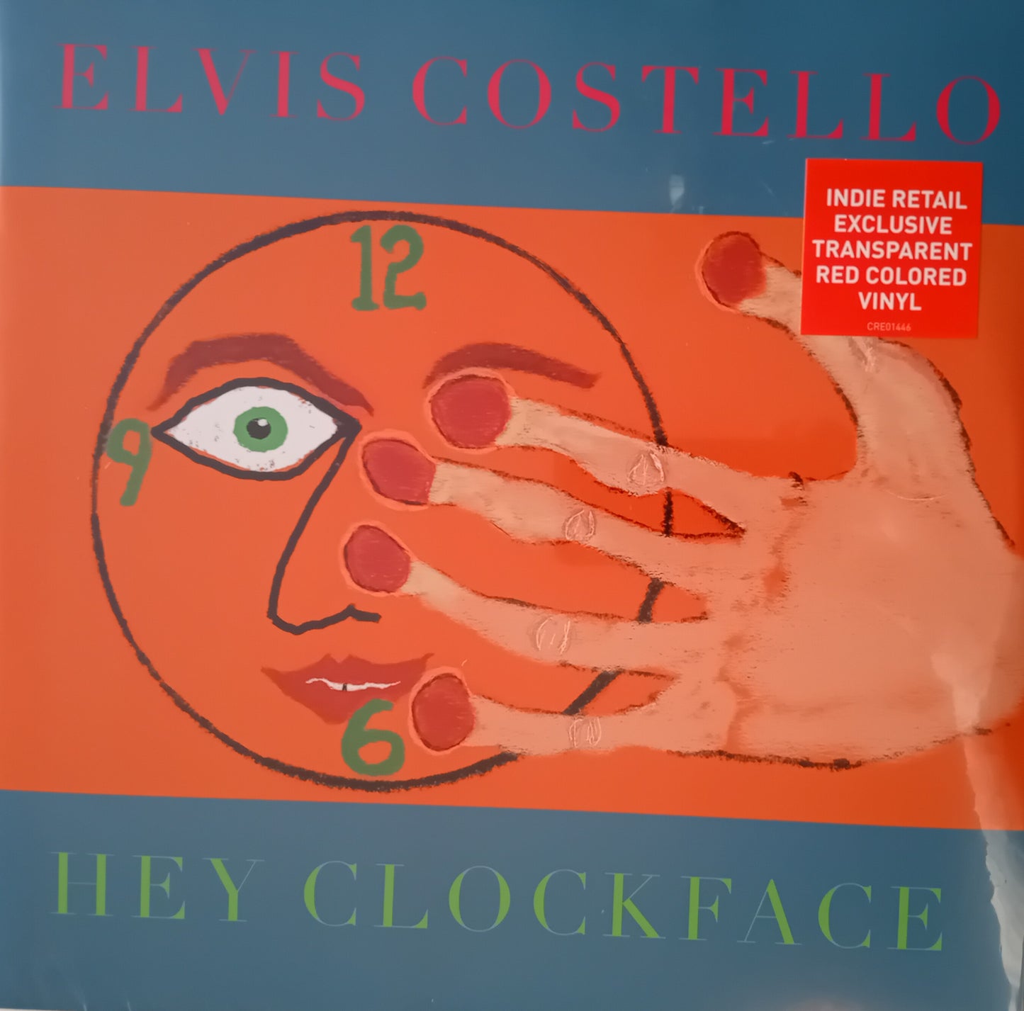 Vinyl album cover for 'Hey Clockface' by Elvis Costello with a hand covering a face design.