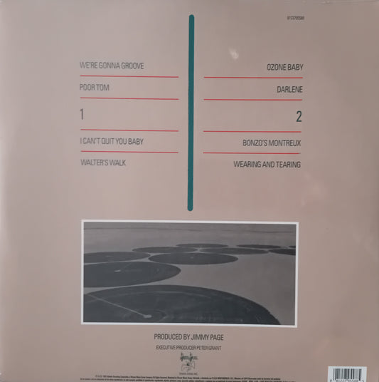Back cover of a vinyl record with track listings and a small image of a road.