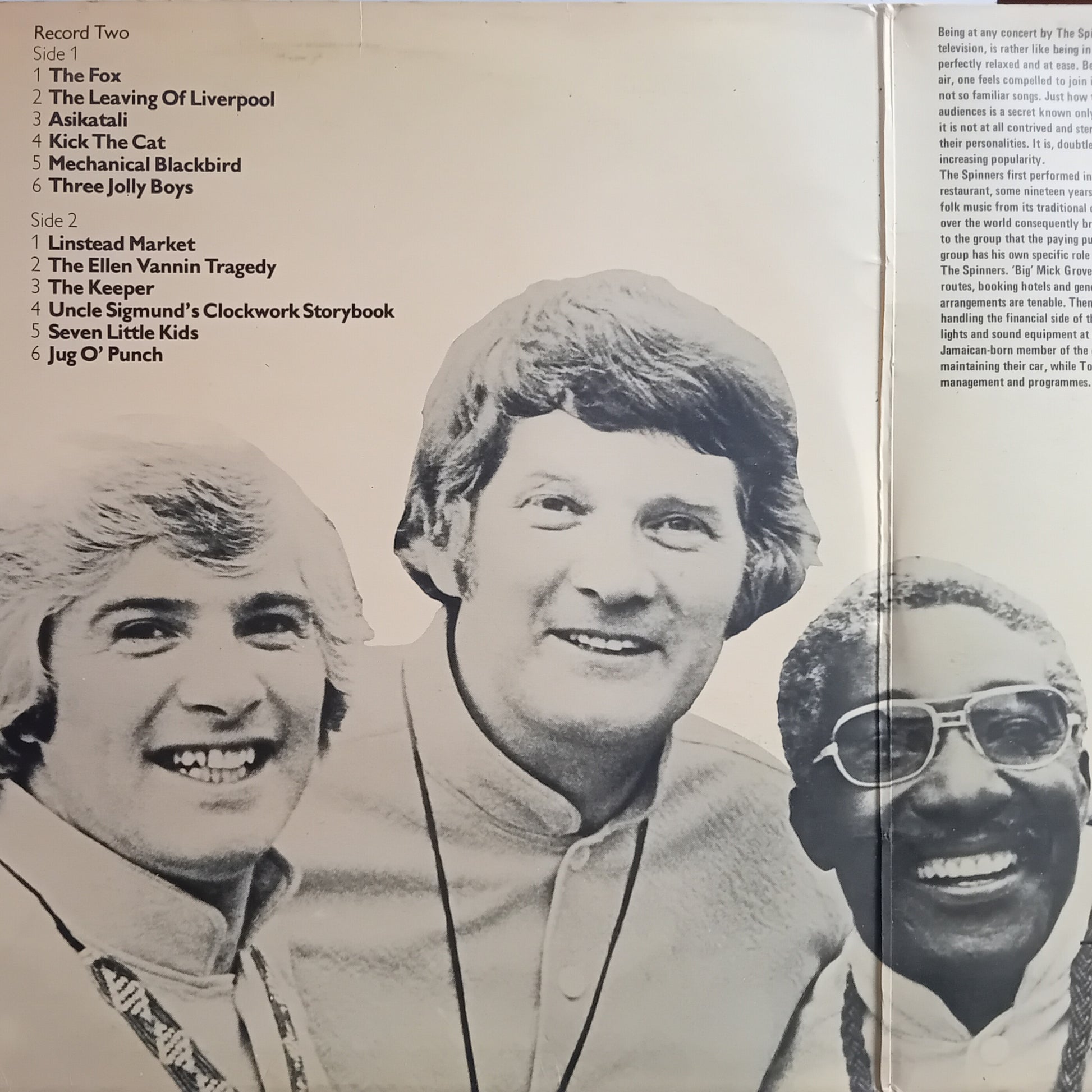 Album cover with three smiling men and a list of song titles on the left side.