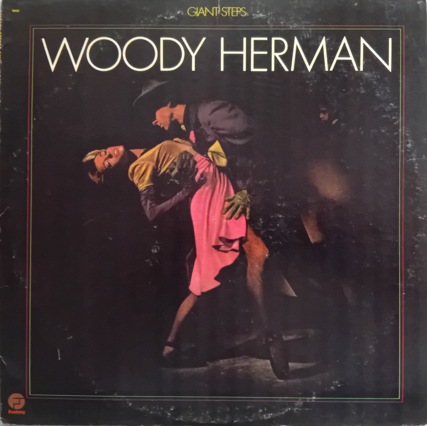 Woody Herman 'Giant Steps' album cover, featuring a dark-toned photograph of a couple dancing tango with the title in large white letters at the top.