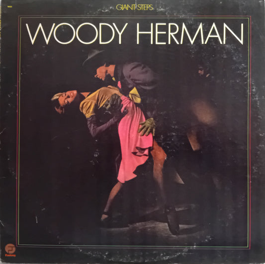 Woody Herman 'Giant Steps' album cover, featuring a dark-toned photograph of a couple dancing tango with the title in large white letters at the top.