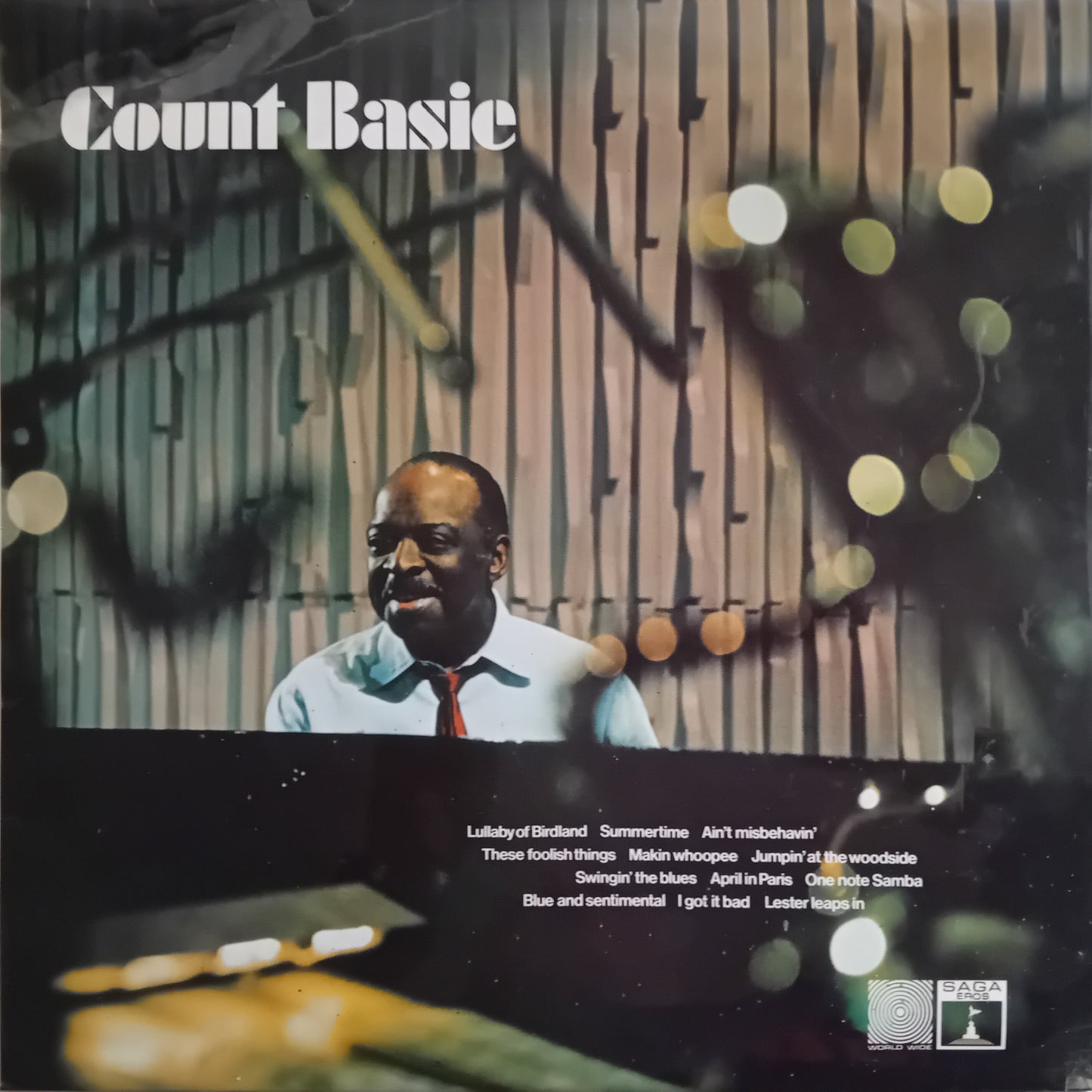 Album cover featuring a man at a piano with decorative elements