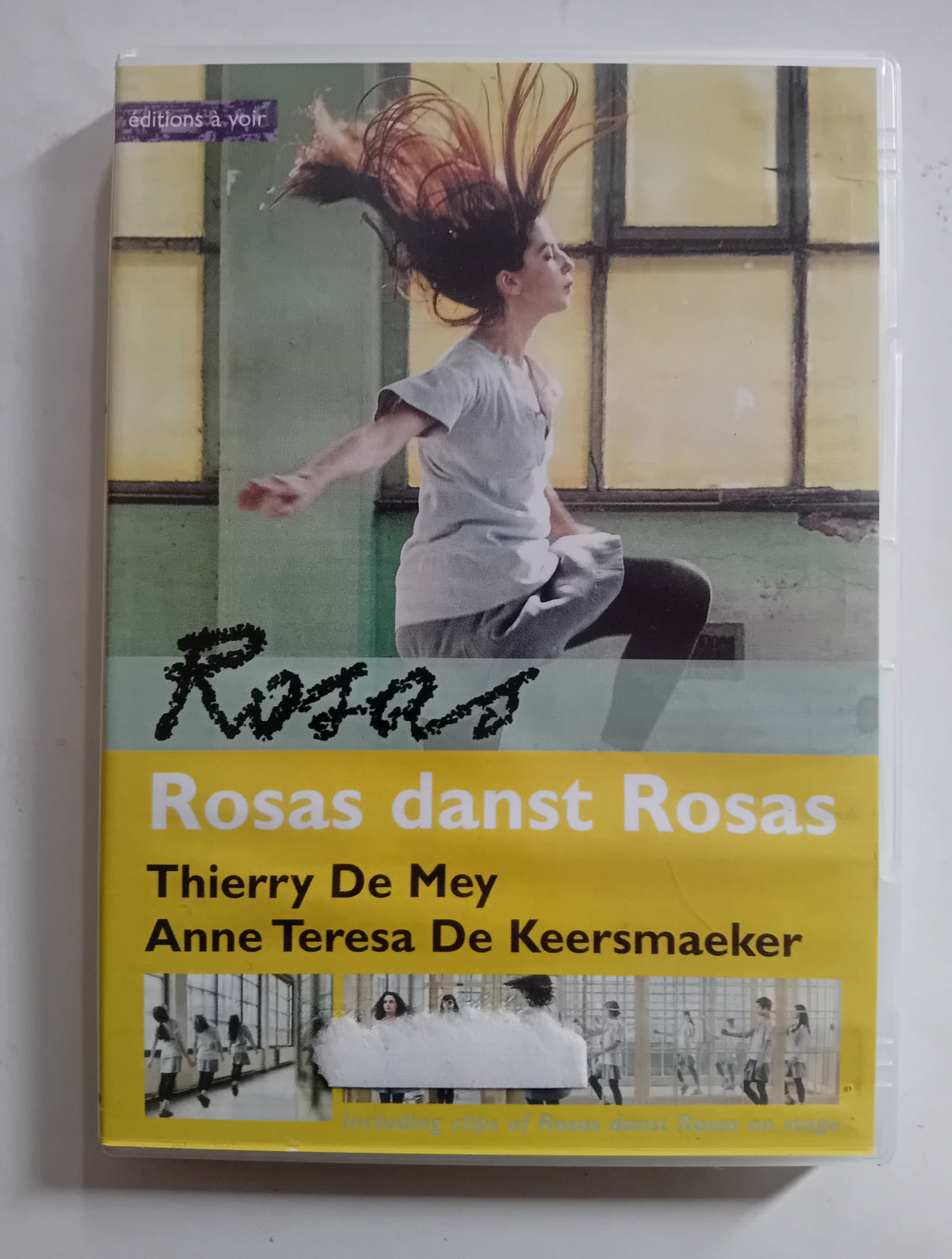 DVD cover of 'Rosas danst Rosas' with a dancer and text on a yellow background
