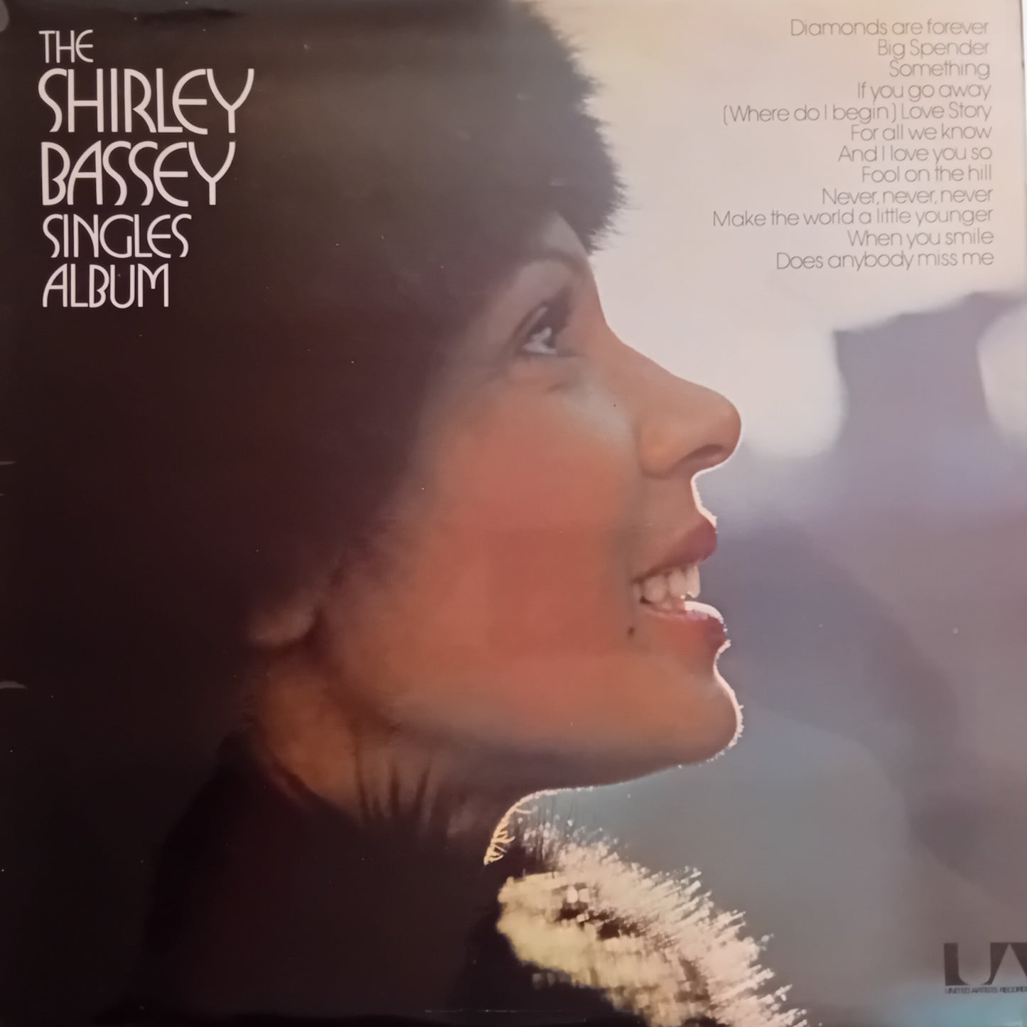 Album cover featuring a profile of a woman with text about 'The Shirley Bassey Singles Album'.