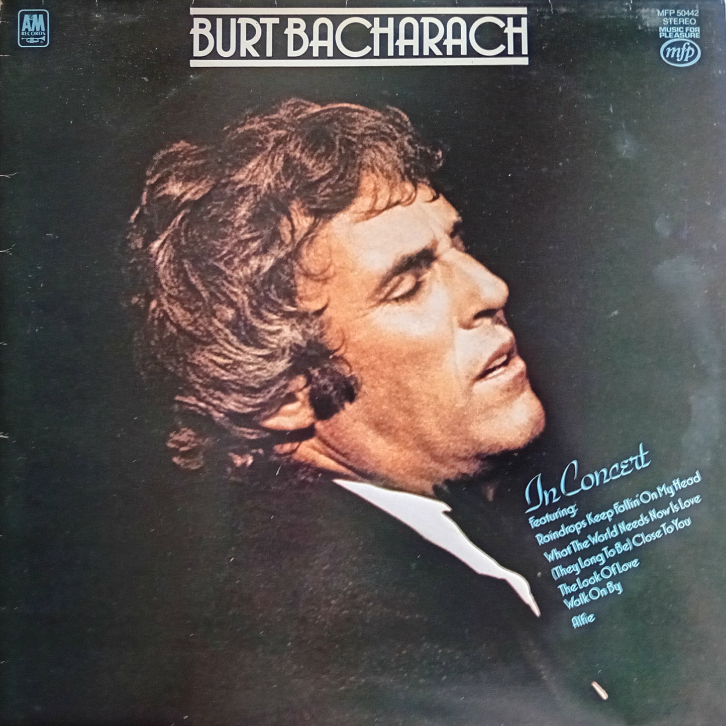 Album cover featuring a profile of a man with text about Burt Bacharach's concert.