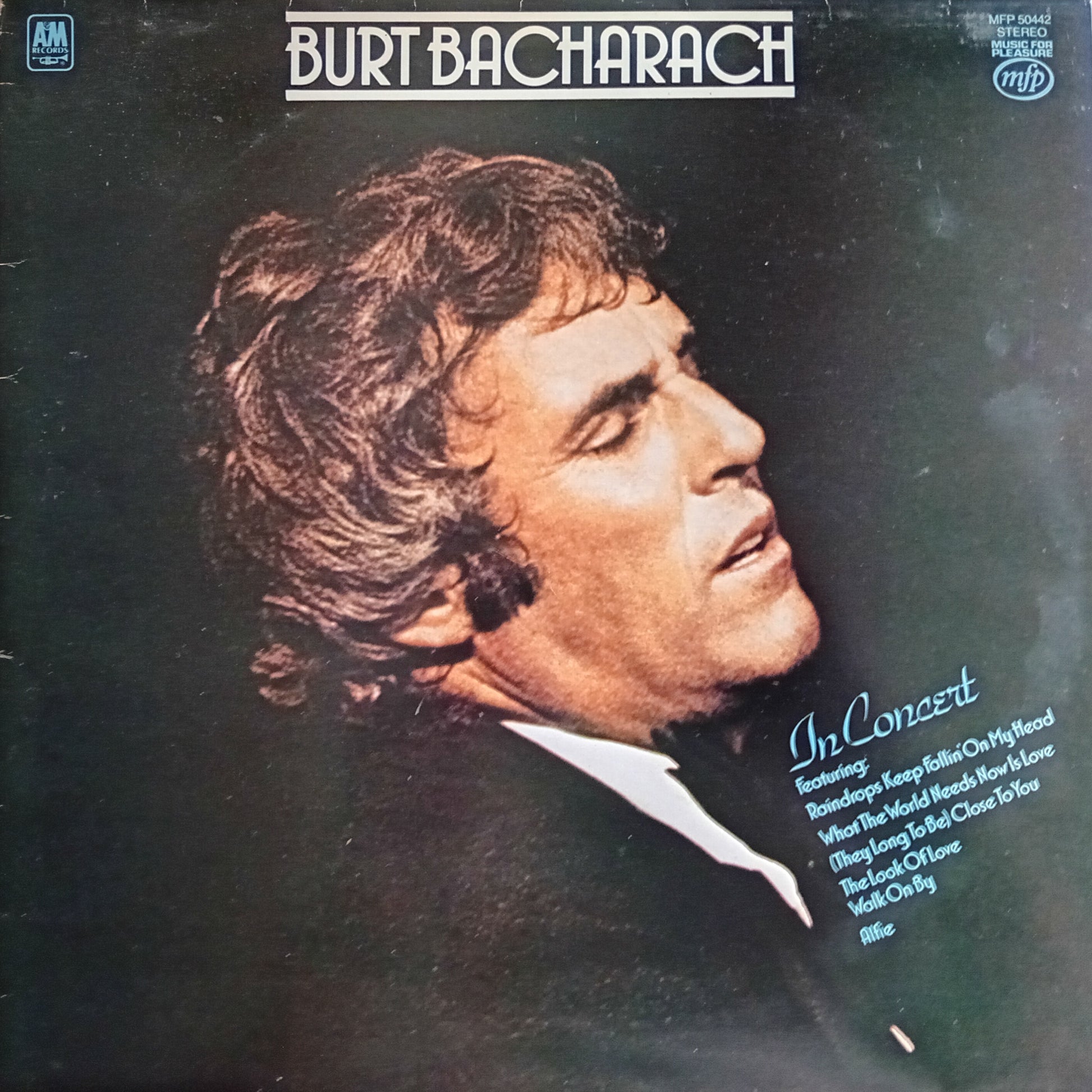 Album cover featuring a profile of a man with text about Burt Bacharach's concert.