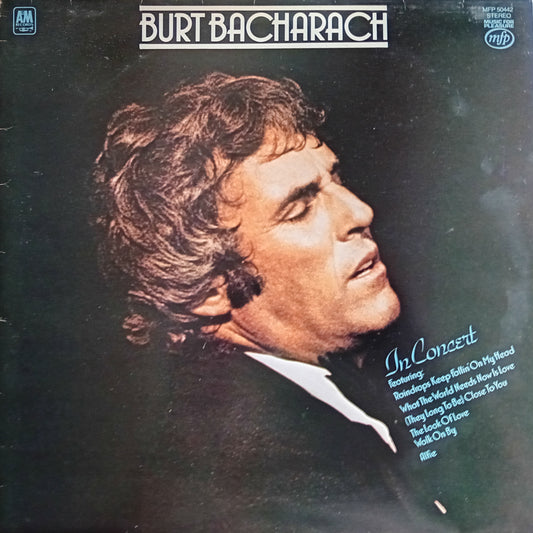 Album cover featuring a profile of a man with text about Burt Bacharach's concert.