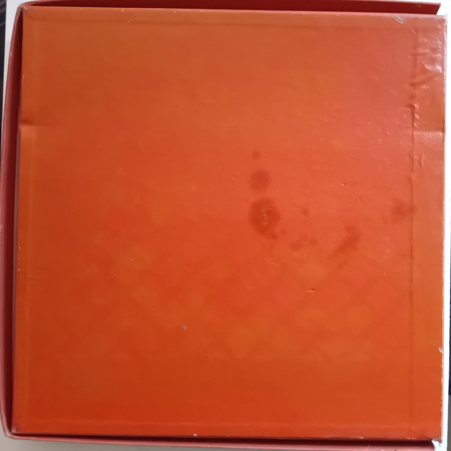 Orange box with a visible brand logo on a white background