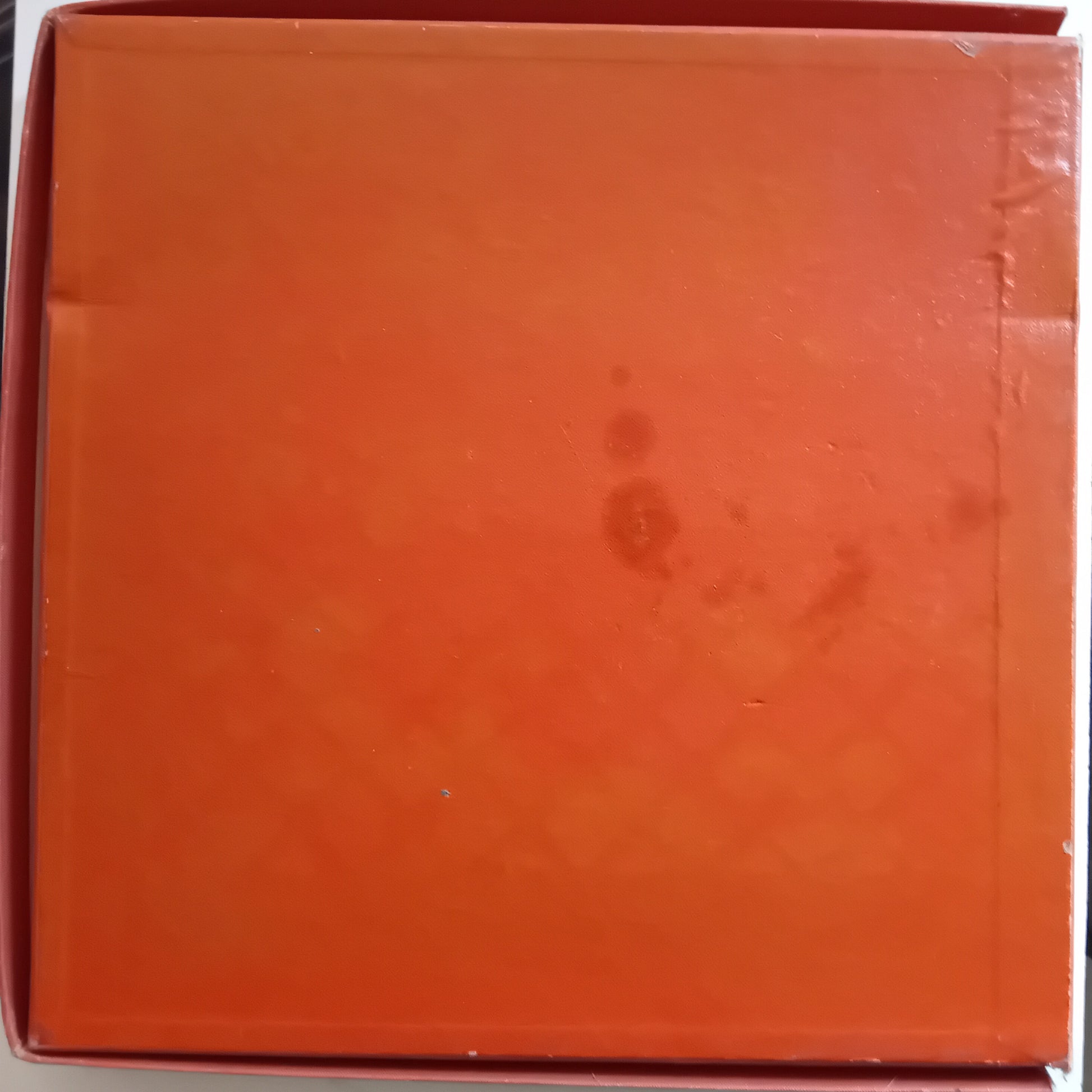 Orange box with a visible brand logo on a white background