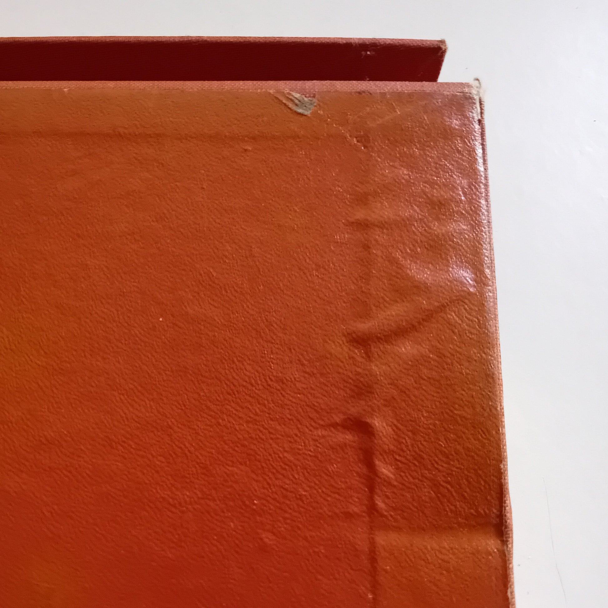 Close-up of a red bound box corner on a white background