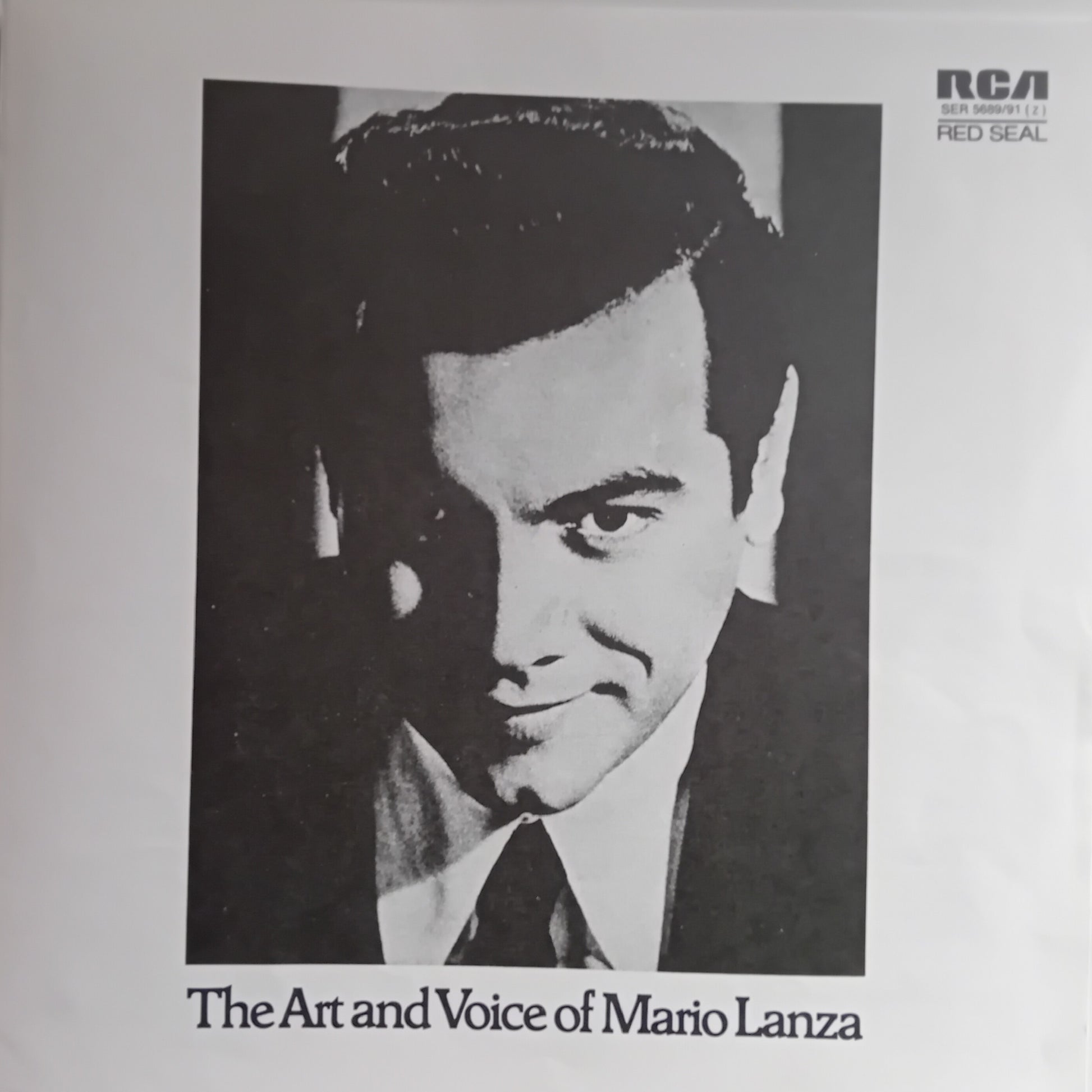 Album cover with a portrait of a man and text 'The Art and Voice of Mario Lanza' on a light gray background.