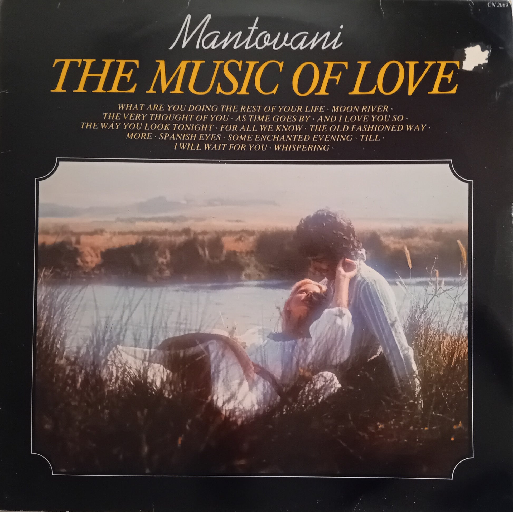 Album cover of 'The Music of Love' by Mantovani with a couple in a field.