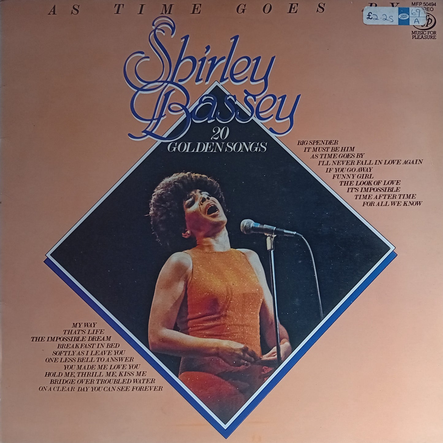 Album cover of Shirley Bassey's '20 Golden Songs' with a woman singing into a microphone.