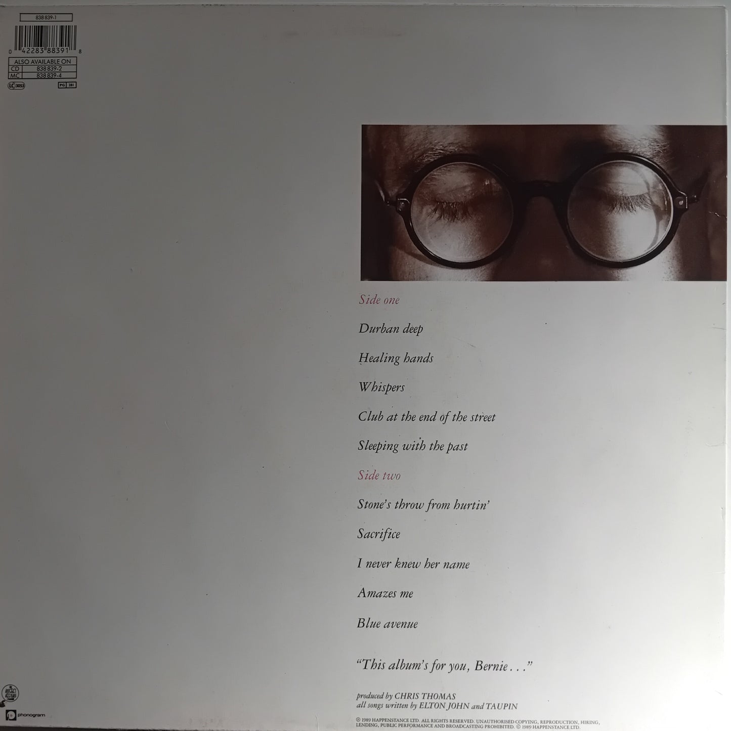 Album cover with a person wearing glasses and text on a plain background