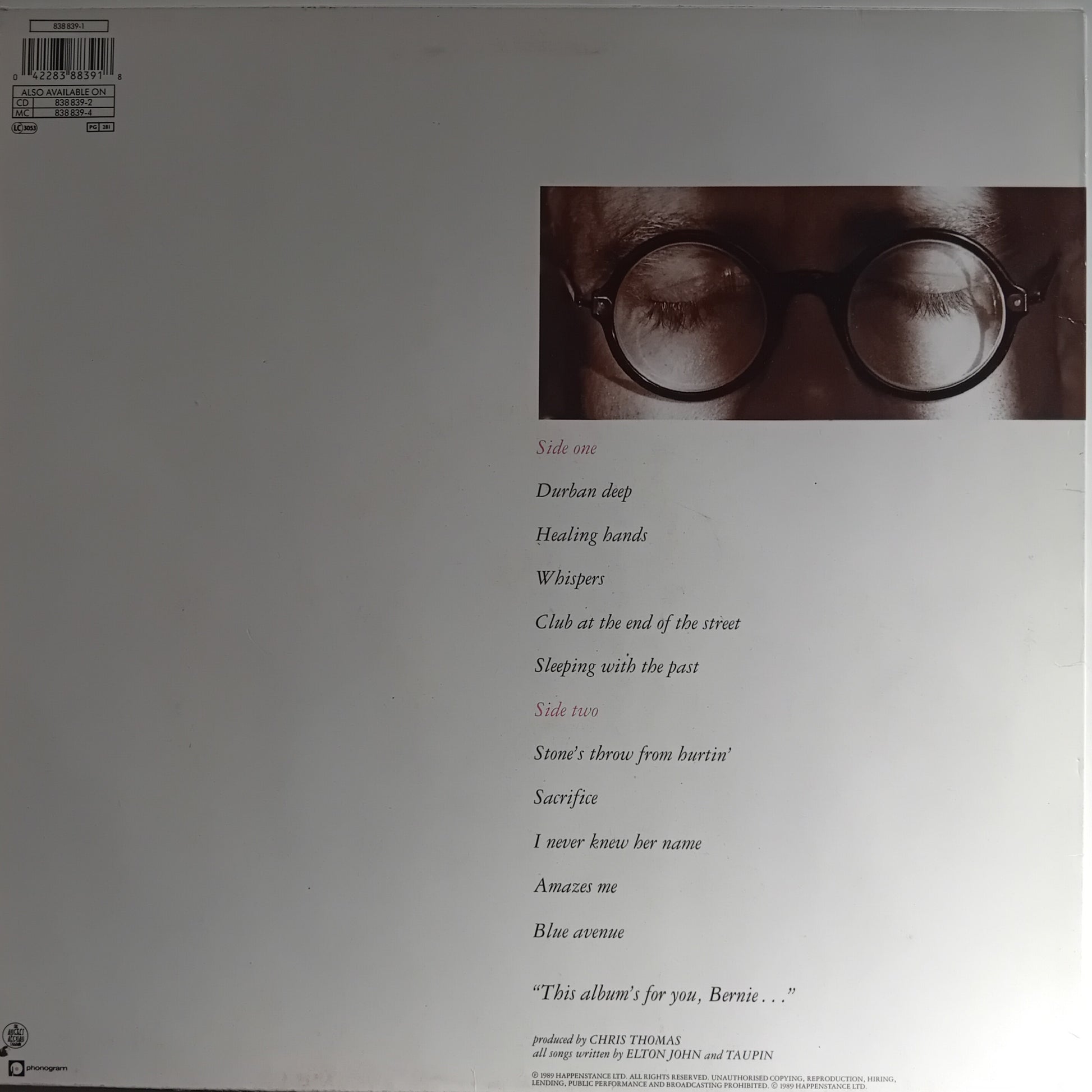 Album cover with a person wearing glasses and text on a plain background