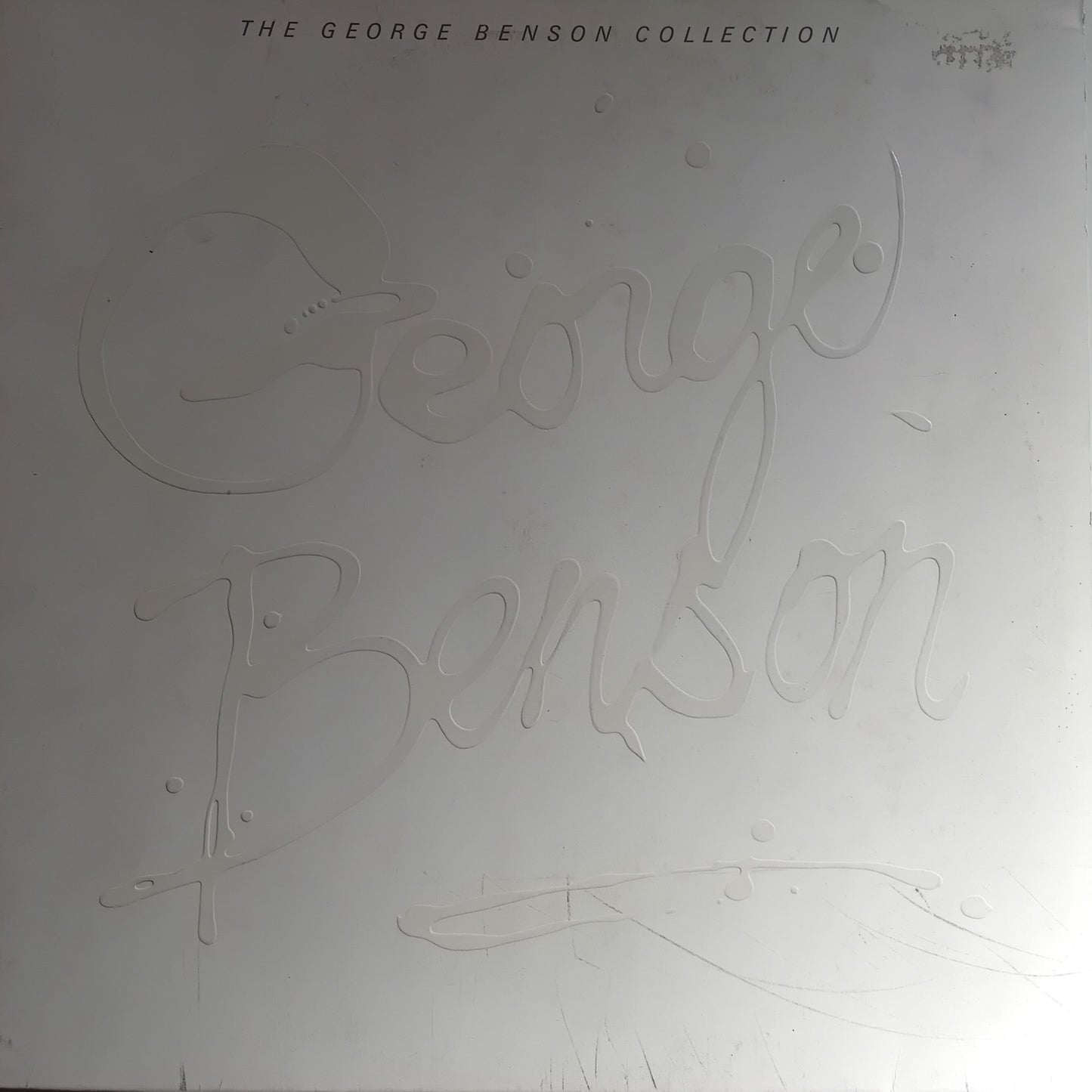 Album cover with 'George Benson' branding on a light gray background