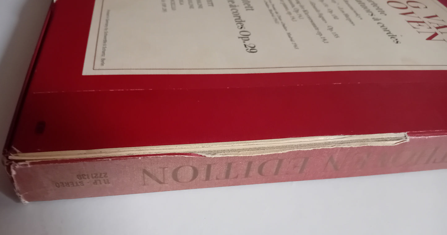 A close-up of a vintage red book or album cover with cream-colored paper labels attached to the top and spine, showing the title 'HARPOON EDITION' in reverse on the spine.